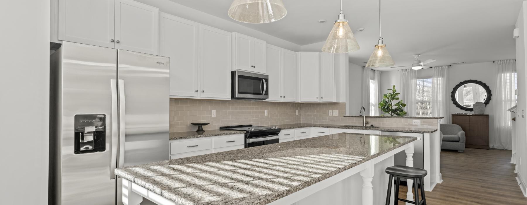 a kitchen with white cabinets