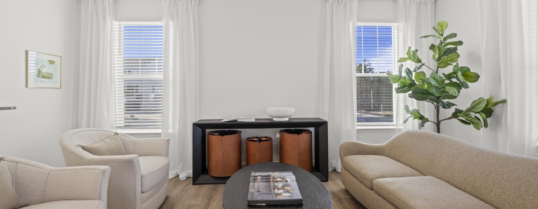 a living room with a table and chairs