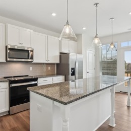 a kitchen with white cabinets